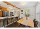 Modern kitchen and dining area with wood floors, stainless steel appliances, and counter seating at 1419 30Th N Ave, St Petersburg, FL 33704