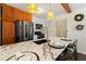 Bright kitchen features a black stainless steel refrigerator, marble counters, and pendant lighting at 1419 30Th N Ave, St Petersburg, FL 33704