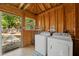 Bright laundry room featuring a wooden ceiling, washer and dryer, and a view of the outside at 1419 30Th N Ave, St Petersburg, FL 33704