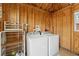 This laundry room has a wooden ceiling, washer and dryer, and a storage rack at 1419 30Th N Ave, St Petersburg, FL 33704