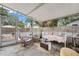 Enclosed patio with stone floors, cushioned seating, and lots of natural light at 1419 30Th N Ave, St Petersburg, FL 33704