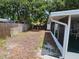 View of the home's backyard, including screened-in lanai and wood fence at 16134 Ravendale Dr, Tampa, FL 33618