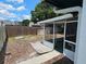 View of the home's backyard, including screened-in lanai and wood fence at 16134 Ravendale Dr, Tampa, FL 33618
