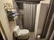 Bathroom featuring a toilet, shower with shower curtain, and a white cabinet at 16134 Ravendale Dr, Tampa, FL 33618