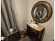 Bathroom features a vanity with a decorative framed mirror, plus a shower curtain at 16134 Ravendale Dr, Tampa, FL 33618
