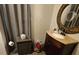 Cozy bathroom with wood vanity, decorative mirror and neutral color scheme at 16134 Ravendale Dr, Tampa, FL 33618