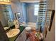 Traditional bathroom featuring a single sink with green countertop, shower, and blue color scheme at 16134 Ravendale Dr, Tampa, FL 33618
