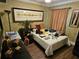 Bedroom with textured walls, ample natural light, and dark wood furniture at 16134 Ravendale Dr, Tampa, FL 33618