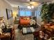 Bedroom with dark flooring, stylish bed frame, ceiling fan, and large window at 16134 Ravendale Dr, Tampa, FL 33618