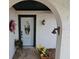 A close-up of a charming front door with stone walkway, plants, and vintage light fixture at 16134 Ravendale Dr, Tampa, FL 33618