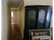 Hallway with tile floors leads past a large curio cabinet with decorative items on display at 16134 Ravendale Dr, Tampa, FL 33618