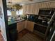 Well-lit kitchen boasts tile floors, updated stainless steel appliances, and light-colored cabinets at 16134 Ravendale Dr, Tampa, FL 33618