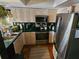 Well-lit kitchen boasts tile floors, updated stainless steel appliances, and light-colored cabinets at 16134 Ravendale Dr, Tampa, FL 33618