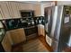 Well-lit kitchen boasts tile floors, updated stainless steel appliances, and light-colored cabinets at 16134 Ravendale Dr, Tampa, FL 33618