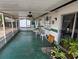 Enclosed lanai with ceiling fan, table and chairs, and view of the backyard at 16134 Ravendale Dr, Tampa, FL 33618