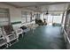 Screened-in lanai with ceiling fan, table and chairs, and view of the backyard at 16134 Ravendale Dr, Tampa, FL 33618