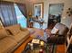 Comfortable living room featuring a sectional sofa, console table and view of the screened-in lanai at 16134 Ravendale Dr, Tampa, FL 33618