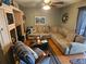 Inviting living room featuring a corner sectional sofa, ceiling fan and light wood entertainment center at 16134 Ravendale Dr, Tampa, FL 33618