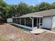 Relaxing screened-in porch with outdoor dining area and access to backyard at 16134 Ravendale Dr, Tampa, FL 33618