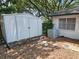 Spacious storage shed in backyard next to central air conditioning unit at 16134 Ravendale Dr, Tampa, FL 33618