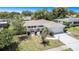 An aerial view showcases this well-maintained home with lush landscaping and a spacious two-car garage at 162 Lagoon Way, Palm Harbor, FL 34684