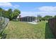 A serene backyard with a screened-in patio and mature trees provides a private oasis at 162 Lagoon Way, Palm Harbor, FL 34684