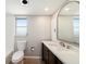 Bathroom with white countertop, framed mirror and a view to the window at 162 Lagoon Way, Palm Harbor, FL 34684