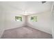 Bedroom with neutral carpet, ceiling fan and two windows with natural light at 162 Lagoon Way, Palm Harbor, FL 34684