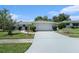 Beautifully landscaped single-story home featuring a two-car garage, arched entryway, and a well-kept front yard at 162 Lagoon Way, Palm Harbor, FL 34684