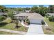Well-maintained home with a two-car garage, manicured landscaping, arched entryway, and a welcoming curb appeal at 162 Lagoon Way, Palm Harbor, FL 34684