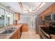 Bright kitchen features stainless steel appliances, a double sink, and wood cabinets and accents at 162 Lagoon Way, Palm Harbor, FL 34684