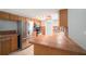 Bright kitchen features stainless steel appliances, and wood cabinets and accents with tile countertop at 162 Lagoon Way, Palm Harbor, FL 34684