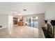 Bright open concept living room has tile floors and glass doors to the screened patio at 162 Lagoon Way, Palm Harbor, FL 34684