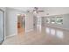 Bright and airy living space featuring large tile flooring, ceiling fan and ample natural light at 162 Lagoon Way, Palm Harbor, FL 34684