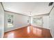 Bright bedroom featuring hardwood floors, a ceiling fan, multiple windows, and neutral wall colors at 162 Lagoon Way, Palm Harbor, FL 34684
