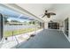 Screened patio with ceiling fans, views of backyard and walkway made of white stones at 162 Lagoon Way, Palm Harbor, FL 34684
