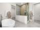 Bright bathroom featuring a glass shower, soaking tub, and sleek finishes at 1625 55Th S St, Gulfport, FL 33707