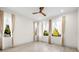 Light-filled bedroom featuring light-colored floors and three large windows with views at 1625 55Th S St, Gulfport, FL 33707
