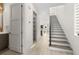 Bright entryway featuring wood-look flooring, a staircase with a modern railing, and a glimpse into the living area at 1625 55Th S St, Gulfport, FL 33707