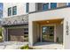 Home's stylish front entrance with glass paneled door, stone accents, modern lighting, and manicured plants at 1625 55Th S St, Gulfport, FL 33707