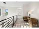 Upstairs hallway seating area with stylish light fixture and views of mature trees at 1625 55Th S St, Gulfport, FL 33707