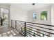 Upstairs hallway features modern lighting and overlooks the front yard and large windows at 1625 55Th S St, Gulfport, FL 33707