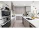 Modern kitchen featuring stainless steel appliances, sleek countertops, and neutral cabinetry, with open layout design at 1625 55Th S St, Gulfport, FL 33707
