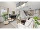 Open-concept living room with a stone fireplace, high ceilings, and direct access to the kitchen at 1625 55Th S St, Gulfport, FL 33707