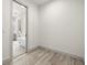 Bright room with wood-look flooring, white walls, and a view into the bathroom at 1625 55Th S St, Gulfport, FL 33707