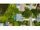Aerial view featuring a backyard pool and verdant landscaping near a tranquil pond at 16317 Colwood Dr, Odessa, FL 33556