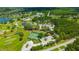Aerial view of community with tennis courts, community center, parking, and golf course at 16317 Colwood Dr, Odessa, FL 33556