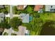 Aerial shot showcasing the home's pool, landscaping, and proximity to a pond at 16317 Colwood Dr, Odessa, FL 33556
