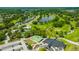 Scenic aerial view of a golf course community showcasing water features and a clubhouse at 16317 Colwood Dr, Odessa, FL 33556