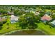 Scenic aerial view of a lakeside community with lush landscaping and beautiful single-Gathering homes at 16317 Colwood Dr, Odessa, FL 33556